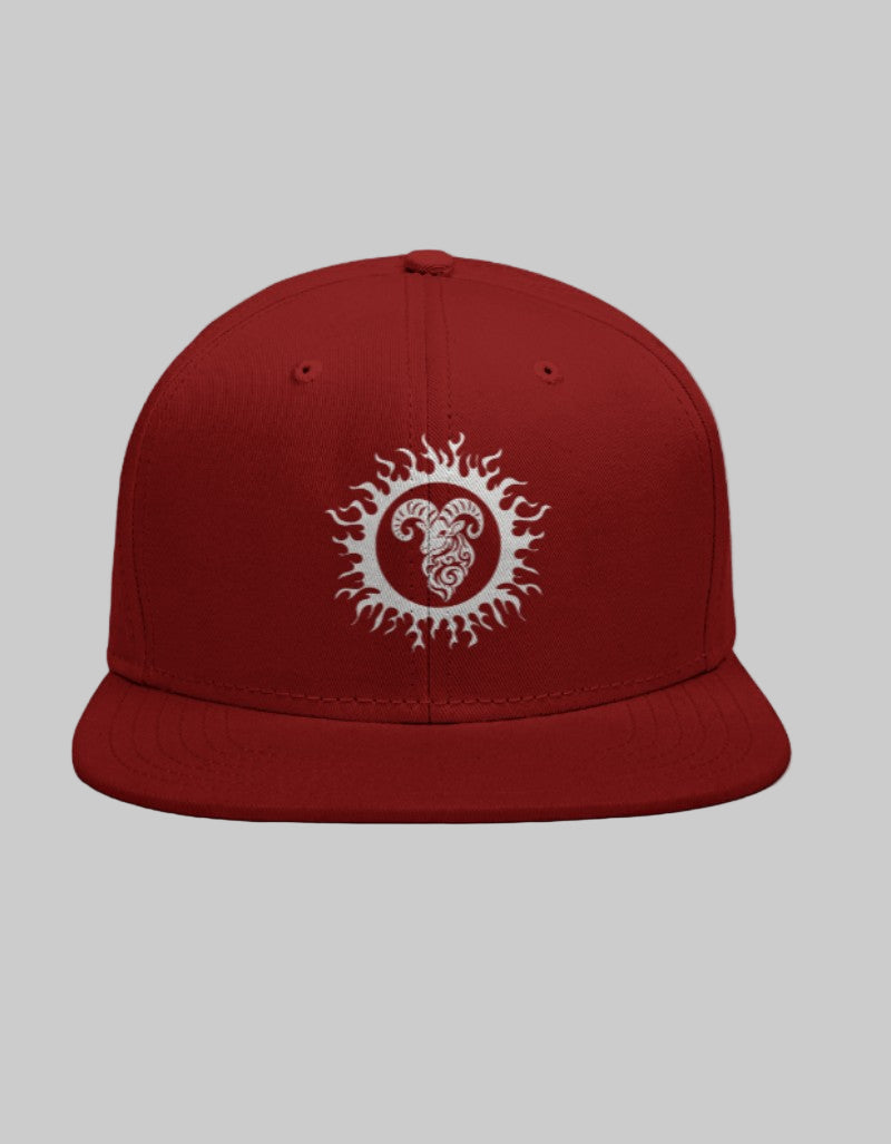 Red snapback hat with a white Aries ram design in a bold circular crest.