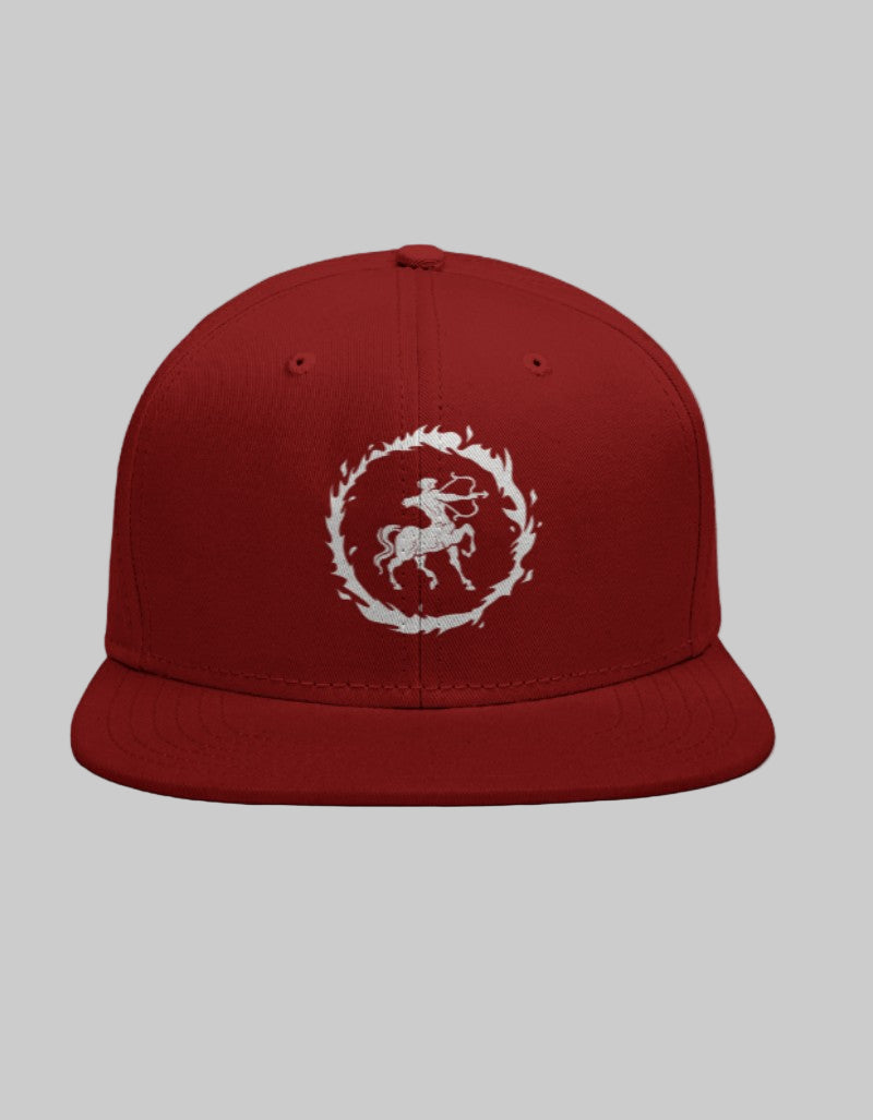 Red snapback cap with white Sagittarius archer symbol inside a blazing flame-shaped border.
