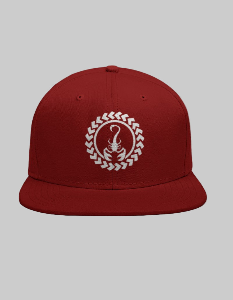 Red snapback hat featuring a white scorpion symbol in a tribal circle embroidery design.