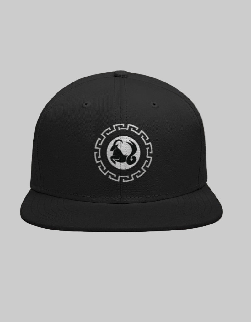 Black snapback cap with black Capricorn mountain goat symbol inside a white geometric circle.