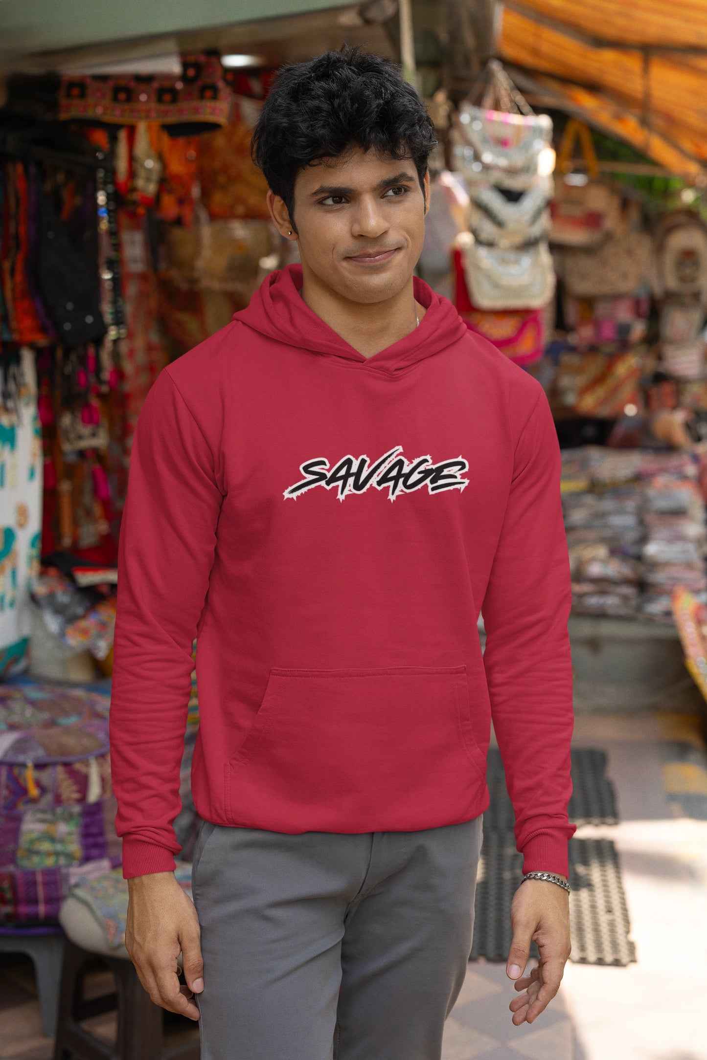 Person wearing a red hoodie with 'SAVAGE' text in a store setting