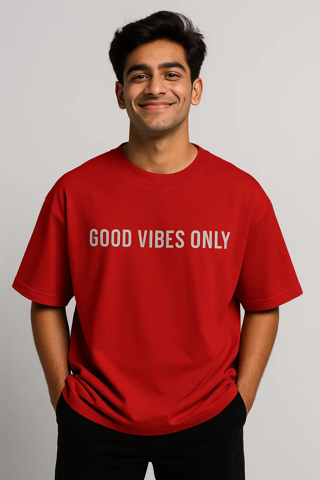 Person wearing a red t-shirt with 'GOOD VIBES ONLY' text on a plain background