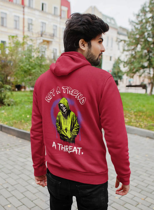Person wearing a red hoodie with a graphic and text on the back, standing outdoors.