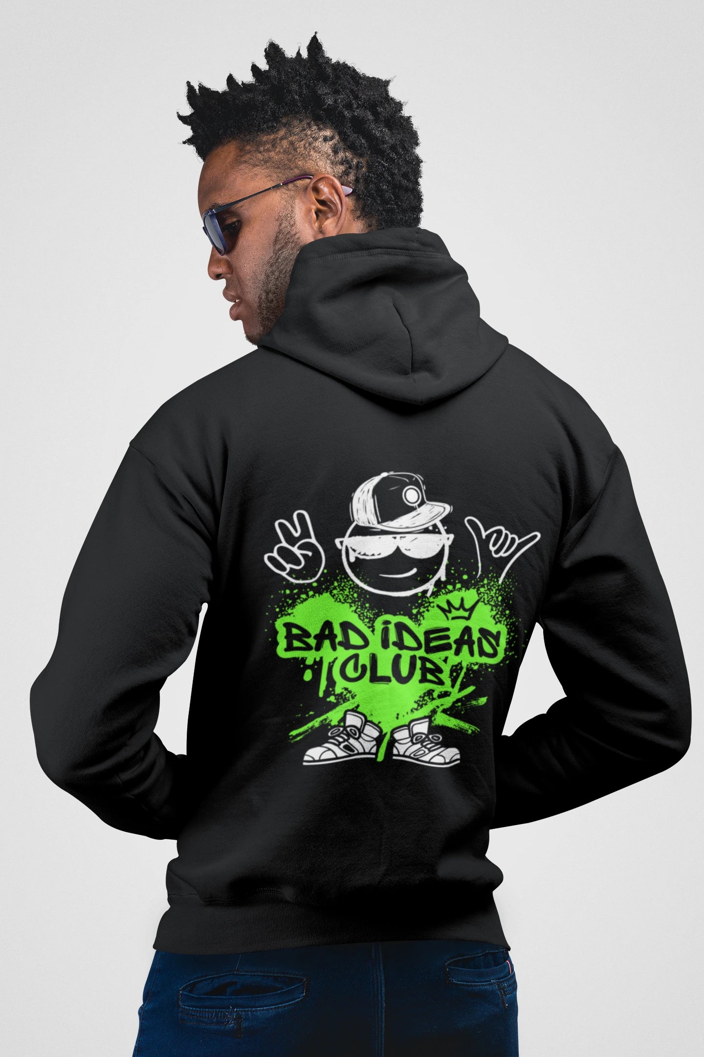 Person wearing a black hoodie with a graphic design on the back, featuring text and a logo.