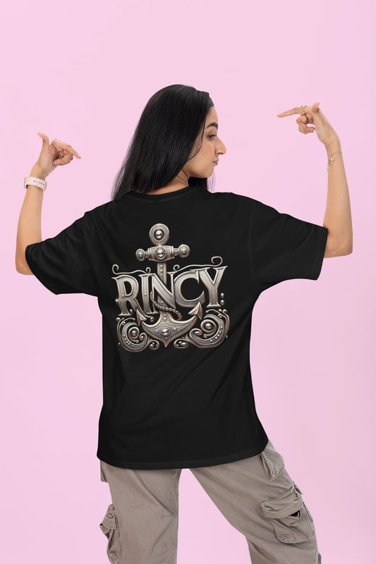 Person wearing a black t-shirt with 'Rincy' design on the back against a pink background
