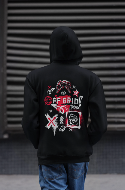 Person wearing a black hoodie with a graphic design on the back against a dark background