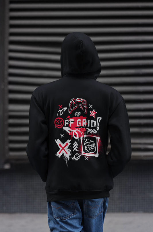Person wearing a black hoodie with a graphic design on the back against a dark background