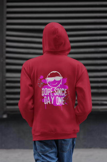 Person wearing a red hoodie with a graphic and text on the back, standing against a dark textured wall.
