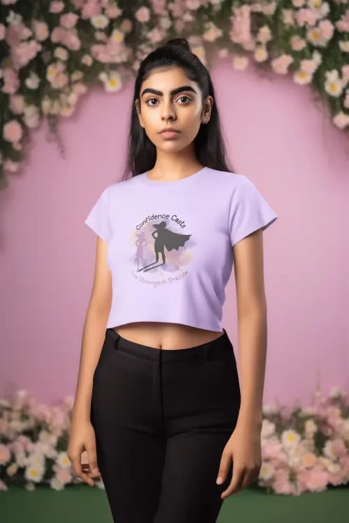 Person wearing a light purple t-shirt with a graphic design against a floral background