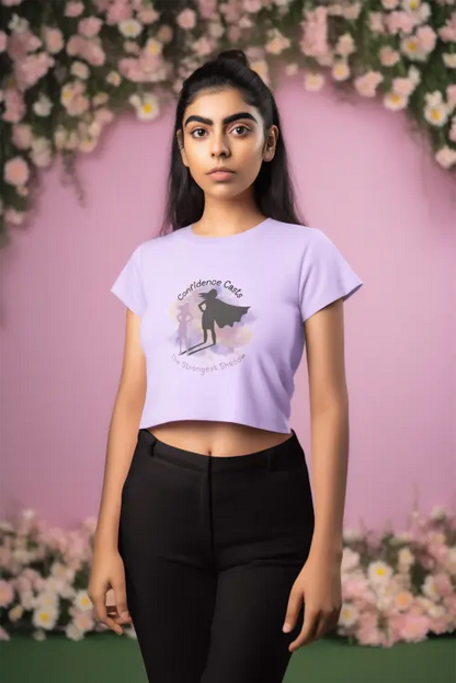 Person wearing a light purple t-shirt with a graphic design against a floral background